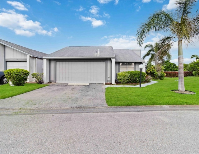 ranch-style home featuring a garage and a front lawn