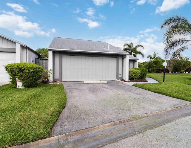 exterior space with a garage and a front lawn