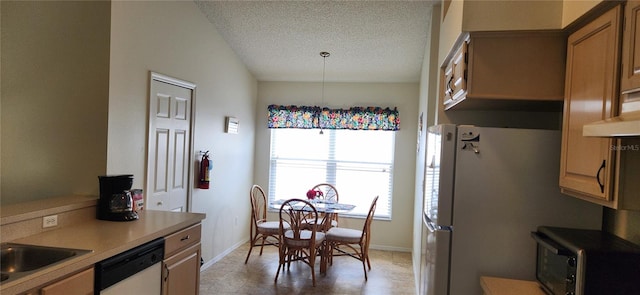 dining space featuring a textured ceiling and sink