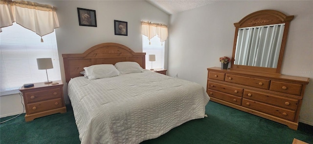 bedroom with vaulted ceiling and dark colored carpet