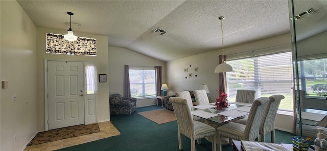 carpeted dining room featuring lofted ceiling, a textured ceiling, and a healthy amount of sunlight