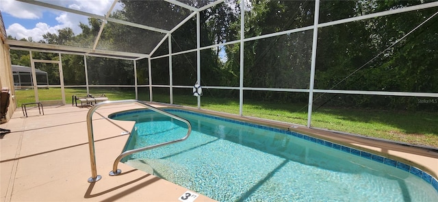 view of pool featuring glass enclosure, a yard, and a patio