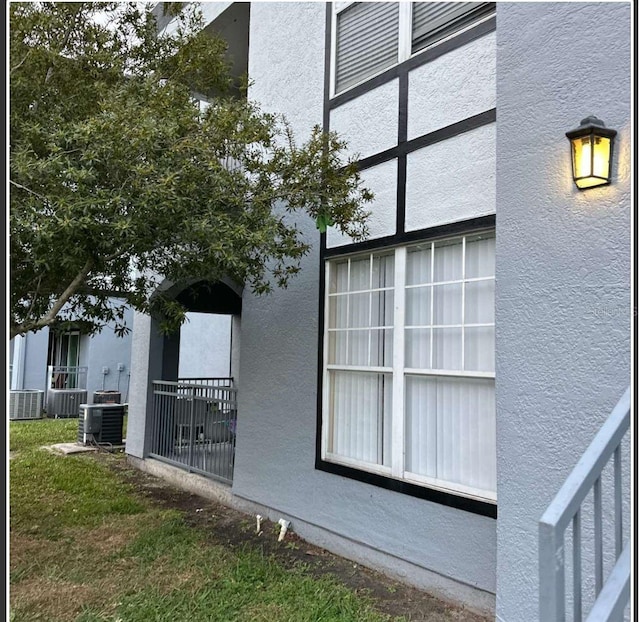 3701 Castle Pines Ln Unit 3914, Orlando, FL 32839 - view of side of home featuring cooling unit and stucco siding