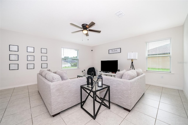 living room with ceiling fan and light tile patterned floors