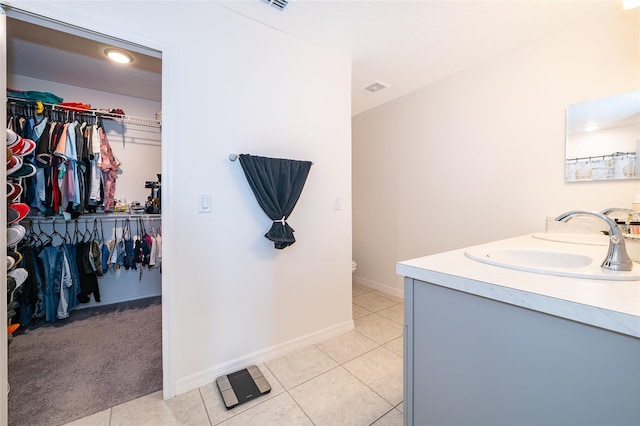 bathroom featuring vanity, toilet, and tile patterned floors