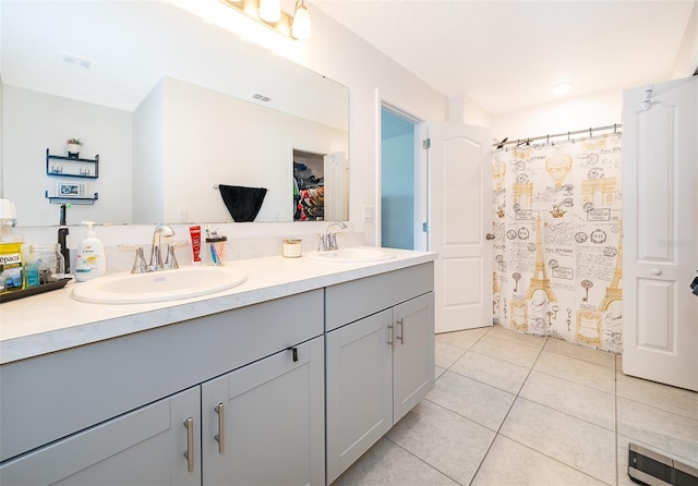 bathroom with tile patterned flooring, vanity, and curtained shower