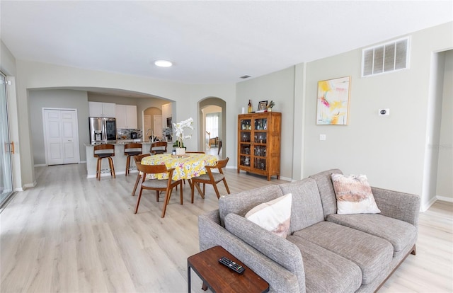 living room with light hardwood / wood-style flooring