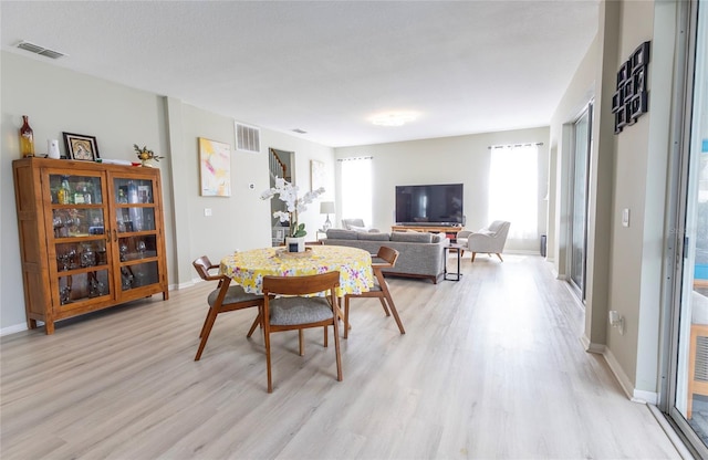 dining space featuring light wood-type flooring