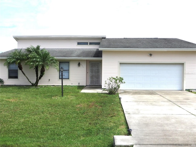 view of front of home with a garage and a front yard