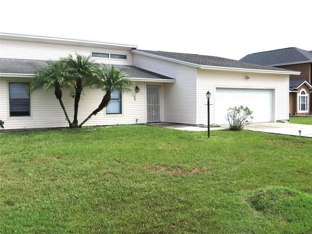 single story home with a garage and a front yard