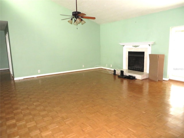 unfurnished living room with parquet floors, ceiling fan, and vaulted ceiling