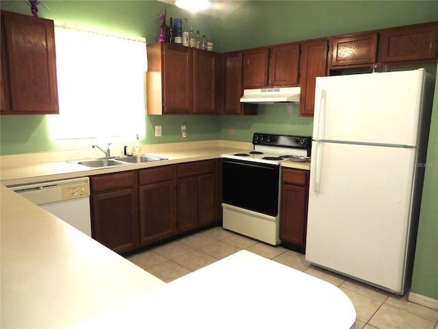 kitchen featuring white appliances, light tile patterned flooring, and sink