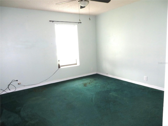 spare room with a textured ceiling, ceiling fan, and carpet