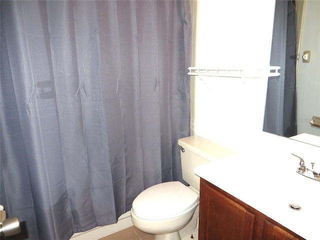 bathroom featuring tile patterned flooring, vanity, toilet, and a shower with curtain