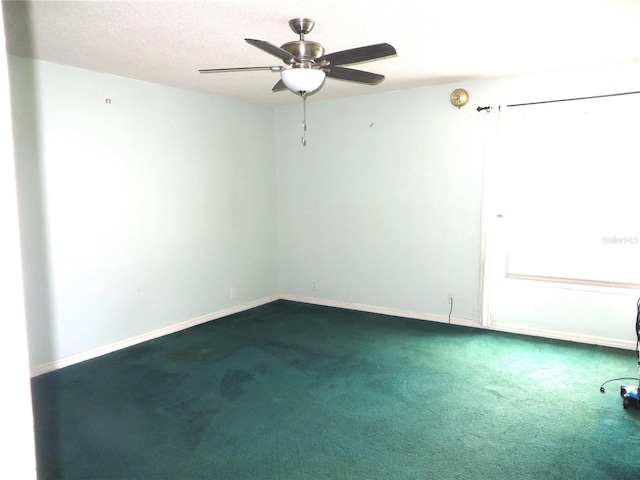 empty room featuring ceiling fan, carpet, and a textured ceiling