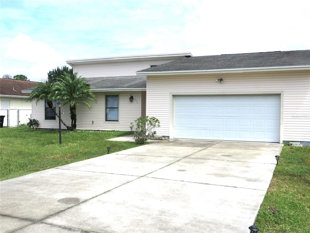 ranch-style home with a garage and a front lawn