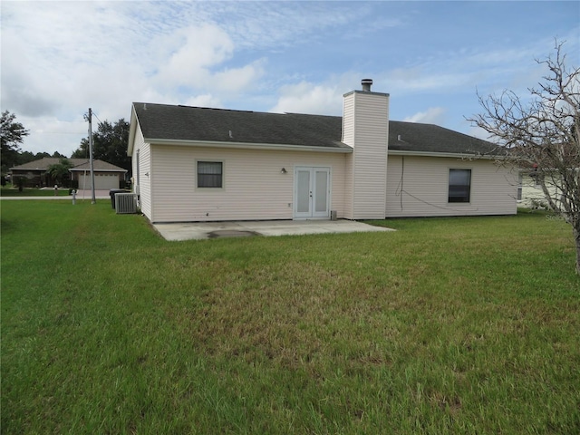 back of property featuring a yard, central AC unit, and a patio area