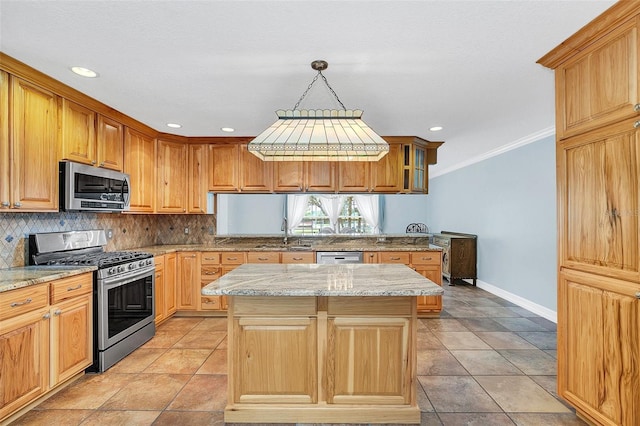 kitchen featuring backsplash, a center island, decorative light fixtures, appliances with stainless steel finishes, and light stone countertops