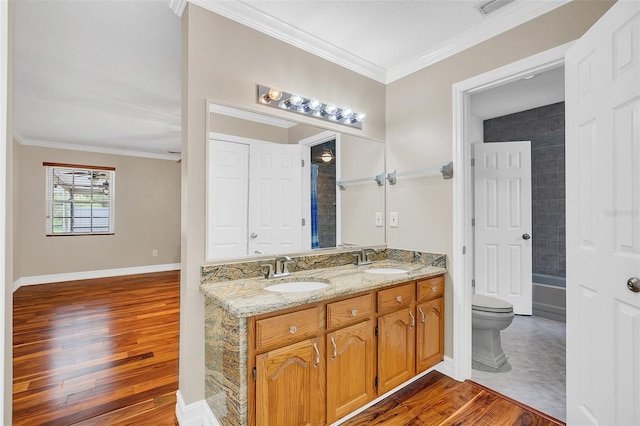 4147 Boggy Creek Rd, Kissimmee, FL 34744 - bathroom featuring ornamental molding, double vanity, wood finished floors, toilet, and washtub / shower combination