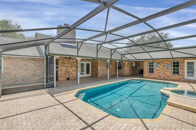 view of swimming pool featuring french doors, glass enclosure, a patio area, and an in ground hot tub