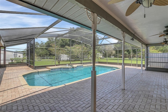 view of pool with ceiling fan, a patio area, glass enclosure, and an in ground hot tub