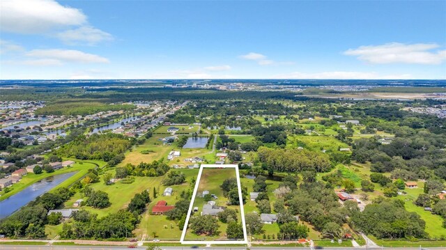 4147 Boggy Creek Rd, Kissimmee, FL 34744 - aerial view of property and surrounding area featuring property boundaries highlighted and a nearby body of water