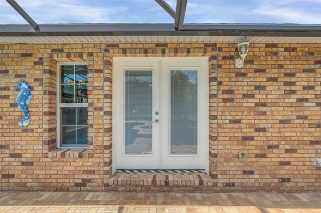 4147 Boggy Creek Rd, Kissimmee, FL 34744 - doorway to property featuring french doors and brick siding