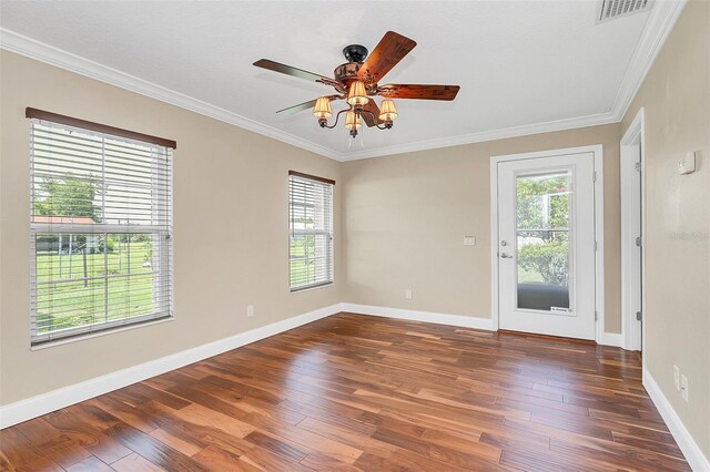 4147 Boggy Creek Rd, Kissimmee, FL 34744 - unfurnished room with healthy amount of natural light, dark wood-style floors, crown molding, and baseboards