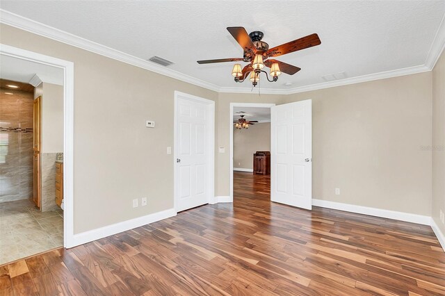 4147 Boggy Creek Rd, Kissimmee, FL 34744 - unfurnished bedroom with wood finished floors, crown molding, baseboards, and a ceiling fan