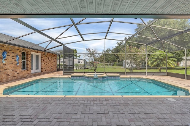 view of swimming pool with glass enclosure and a patio area