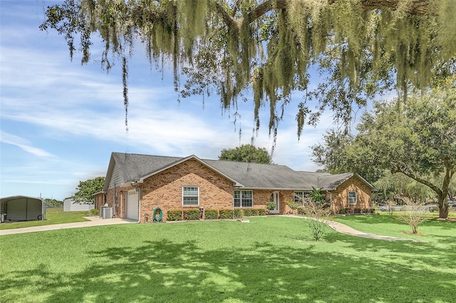 single story home with a garage, a front yard, and central AC unit