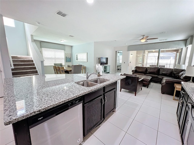 kitchen featuring visible vents, light tile patterned flooring, a sink, dishwasher, and open floor plan