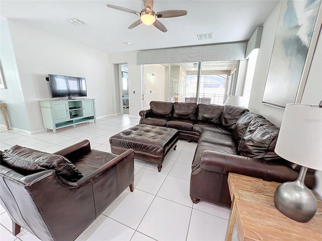 living room featuring light tile patterned floors, visible vents, baseboards, and ceiling fan