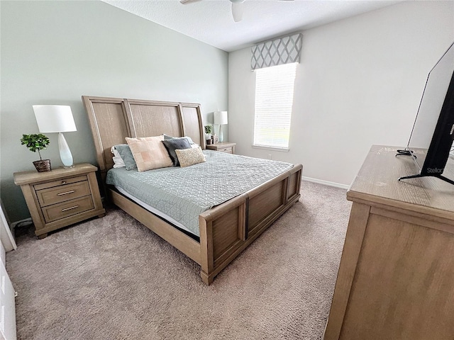 bedroom featuring light carpet, ceiling fan, and baseboards