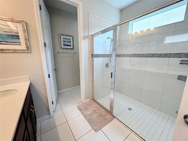 full bathroom with tile patterned floors, a shower stall, vanity, and baseboards