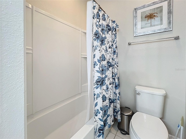 bathroom featuring tile patterned floors, toilet, and shower / tub combo with curtain