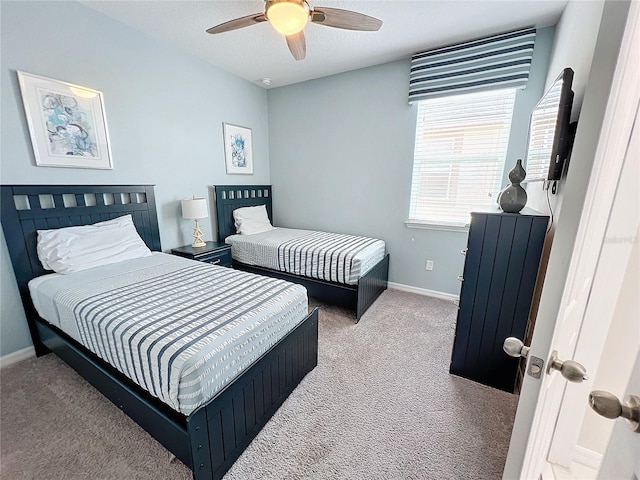 bedroom with a ceiling fan, baseboards, carpet floors, and a textured ceiling