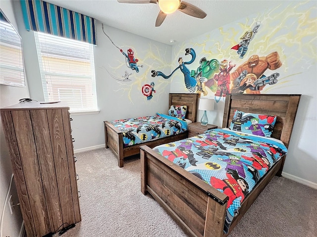 bedroom with baseboards, carpet, a ceiling fan, and a textured ceiling