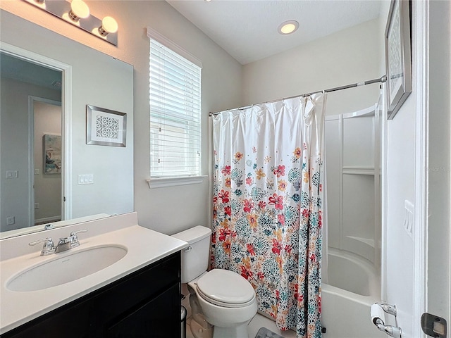 full bath with toilet, vanity, and shower / tub combo