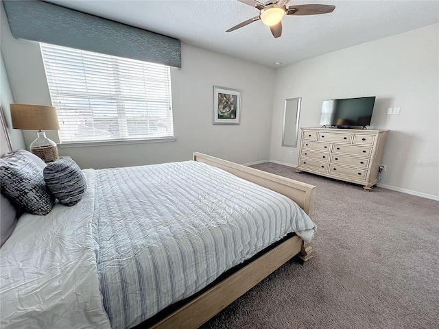 bedroom featuring baseboards, a textured ceiling, ceiling fan, and carpet flooring