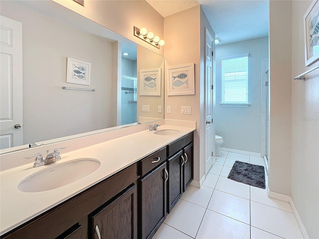 bathroom with tile patterned flooring, a shower stall, toilet, and a sink