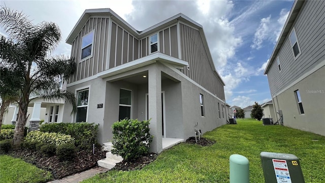 view of front facade with a front lawn and central AC