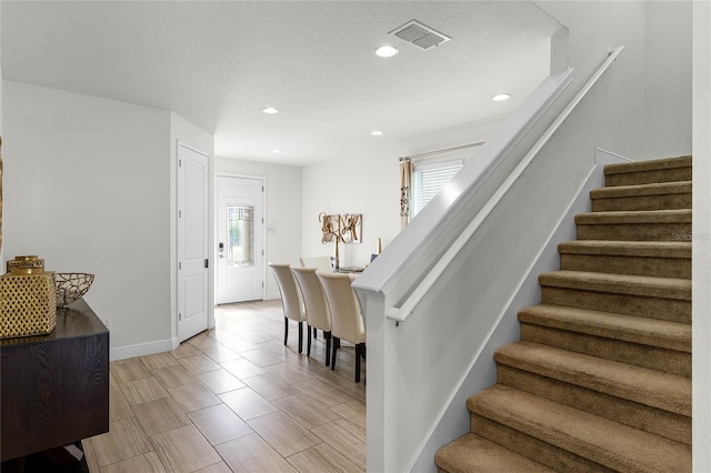 stairway with a textured ceiling