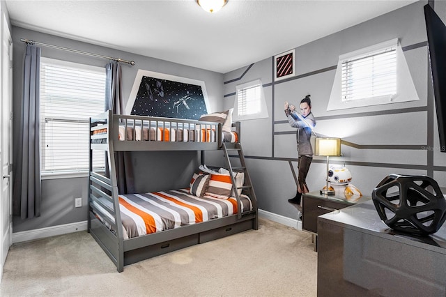 bedroom featuring light colored carpet and multiple windows