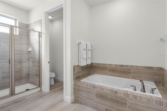 bathroom with toilet and shower with separate bathtub