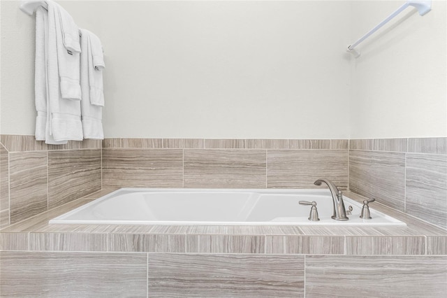 bathroom featuring tiled tub