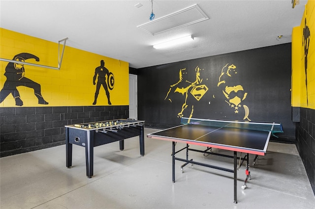 game room featuring a textured ceiling