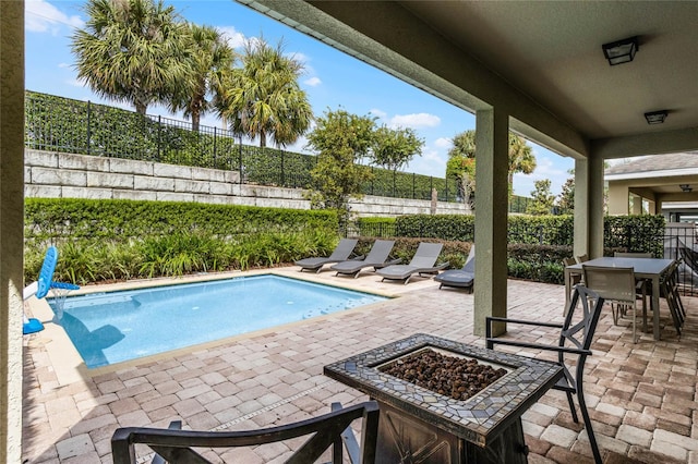 view of pool featuring a fire pit and a patio area