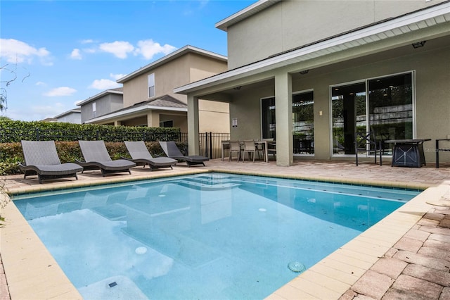 view of swimming pool with a patio area