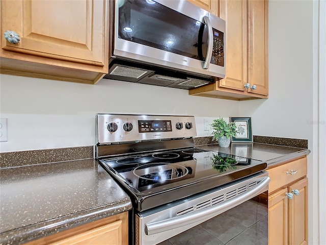 kitchen featuring light brown cabinets, appliances with stainless steel finishes, and tile patterned floors